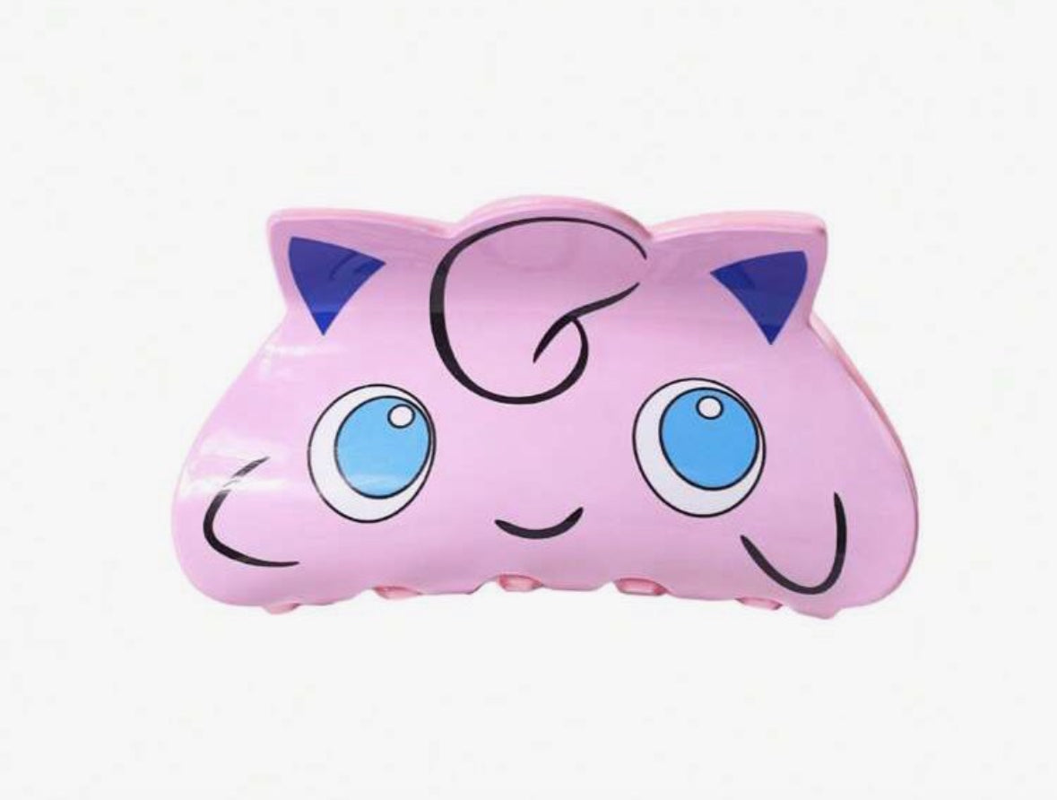 Pink Jigglypuff-shaped plush toy with blue eyes and ears.