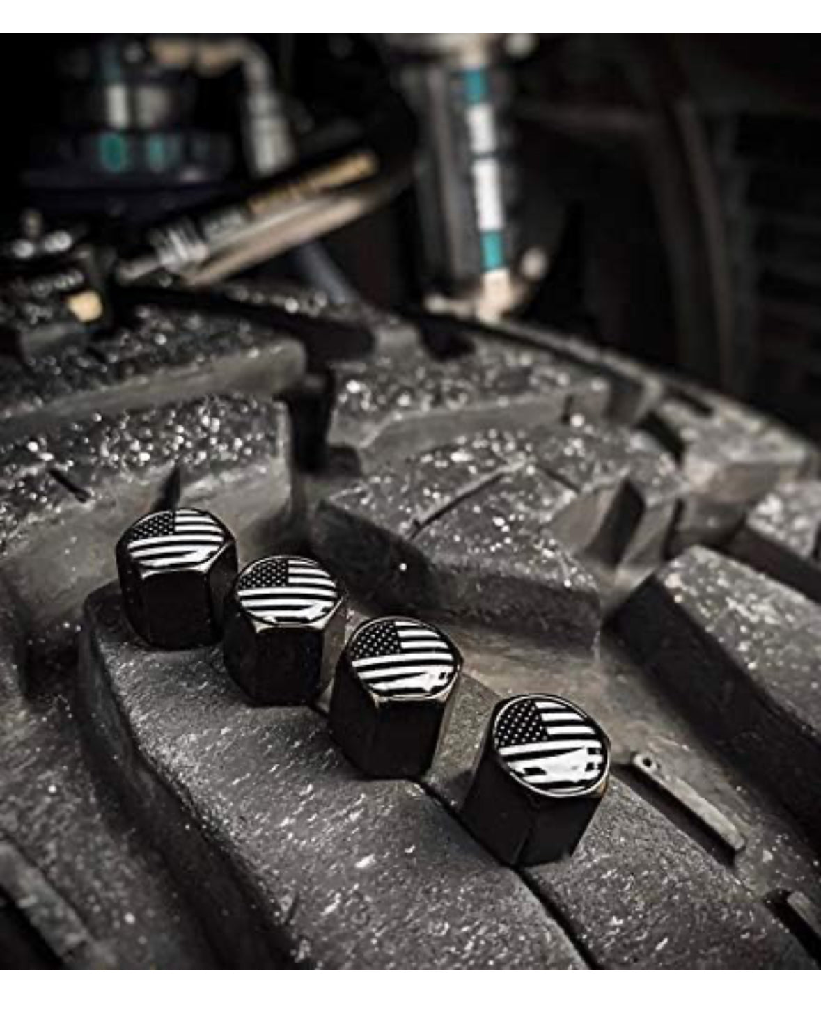 Black American flag valve stem caps on tire tread.