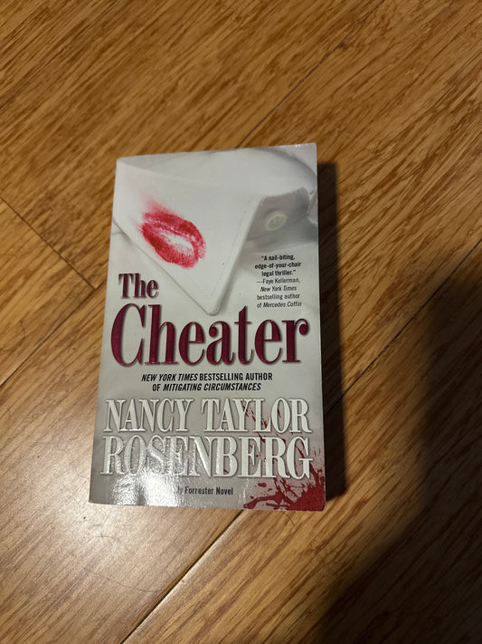 Book cover of The Cheater by Nancy Taylor Rosenberg on wooden floor.