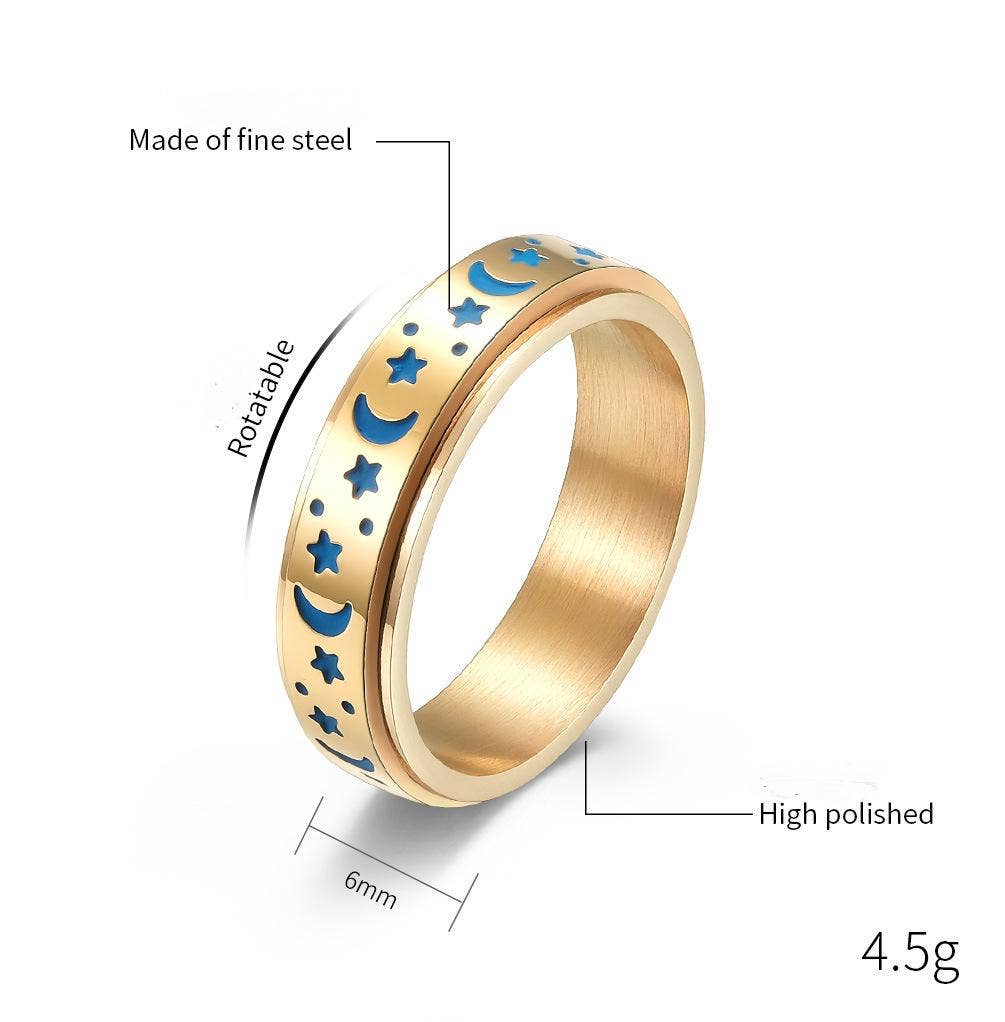 Gold spinner ring with blue moon and star designs, 6mm wide, 4.5g.