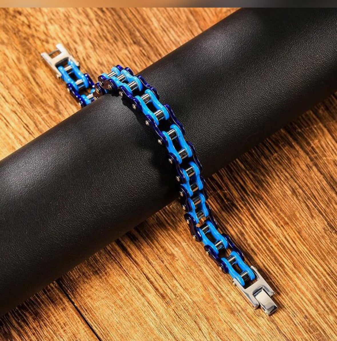 Blue and black motorcycle chain bracelet on leather roll.