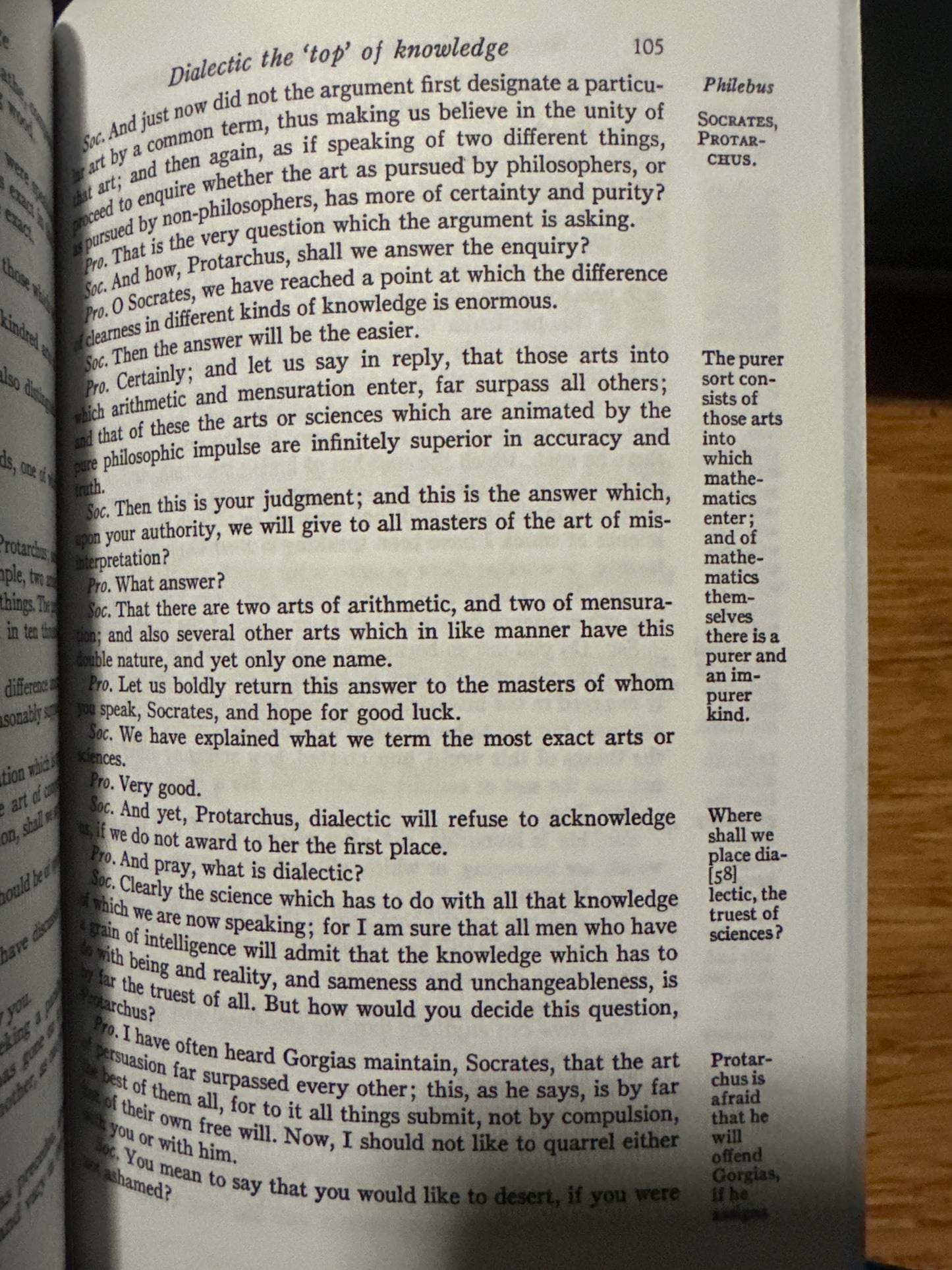 Open book page discussing philosophical dialogue, featuring Socrates and Protarchus.