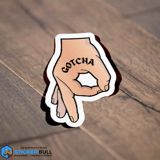 Cartoon hand pointing with GOTCHA text sticker