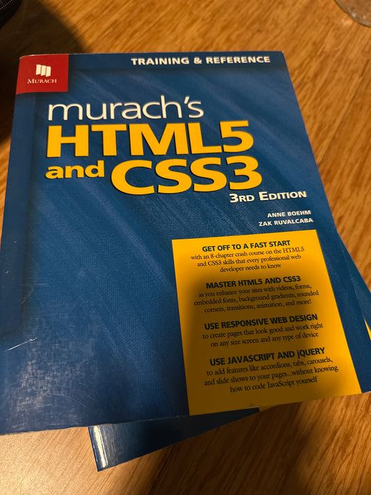 Murachs HTML5 and CSS3 3rd Edition book on wooden table