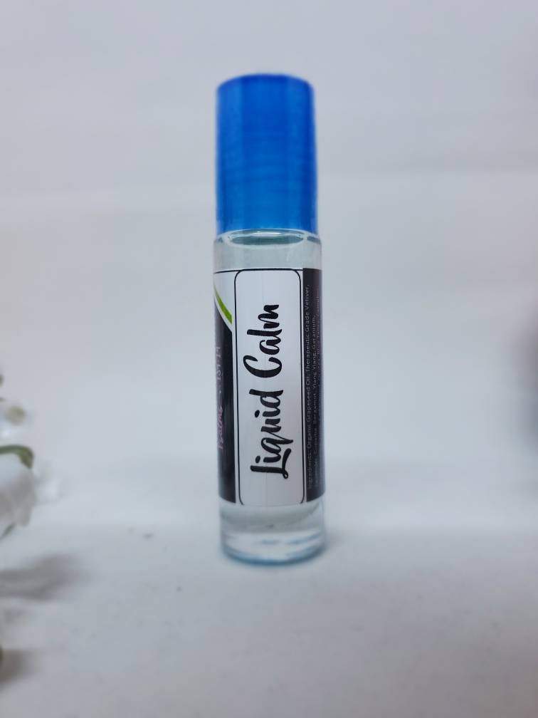 Clear glass roll-on bottle labeled Liquid Calm with blue cap.