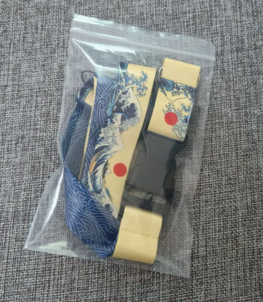 Japanese-inspired lanyard with wave and woman design in plastic bag.