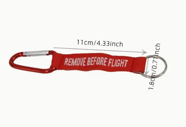 Red REMOVE BEFORE FLIGHT keychain with carabiner and measurements.