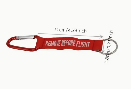 Red REMOVE BEFORE FLIGHT keychain with carabiner and measurements.
