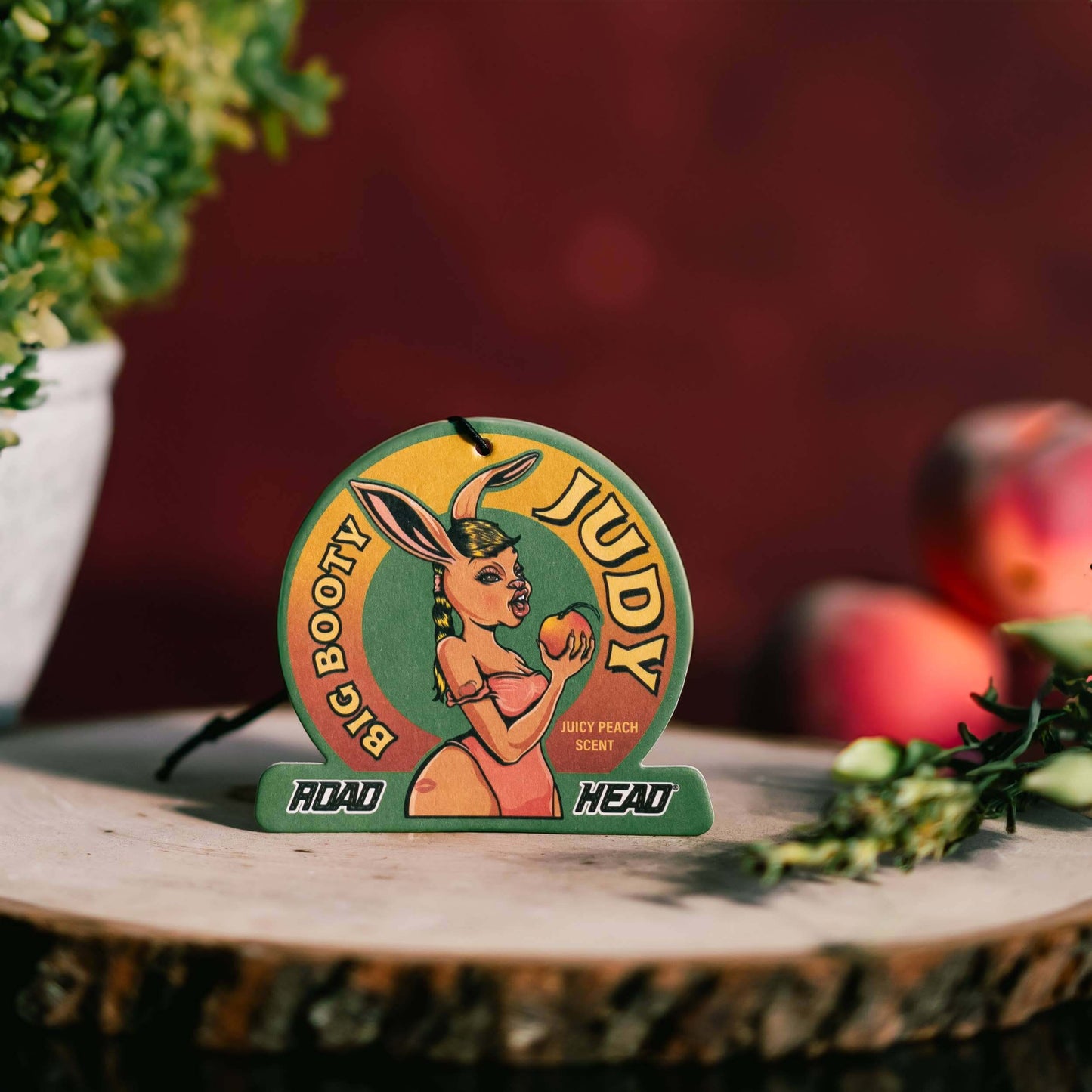 Judy Big Booty Road Head air freshener with peach scent design.