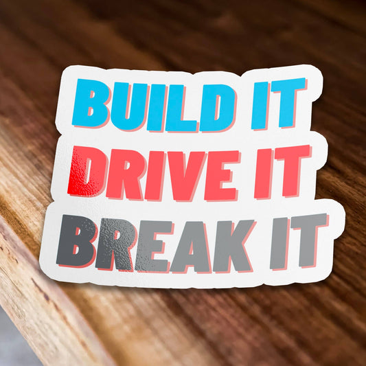 Motivational sticker with text BUILD IT DRIVE IT BREAK IT in colorful letters.