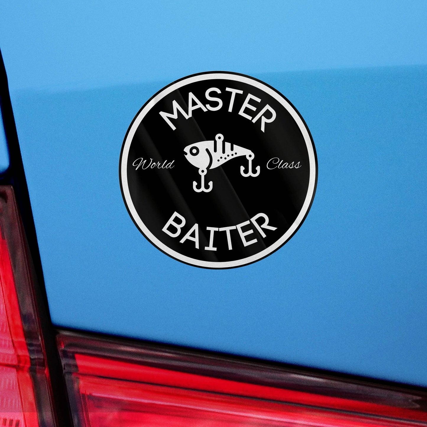 Circular Master Baiter sticker with fishing lure design on blue car.
