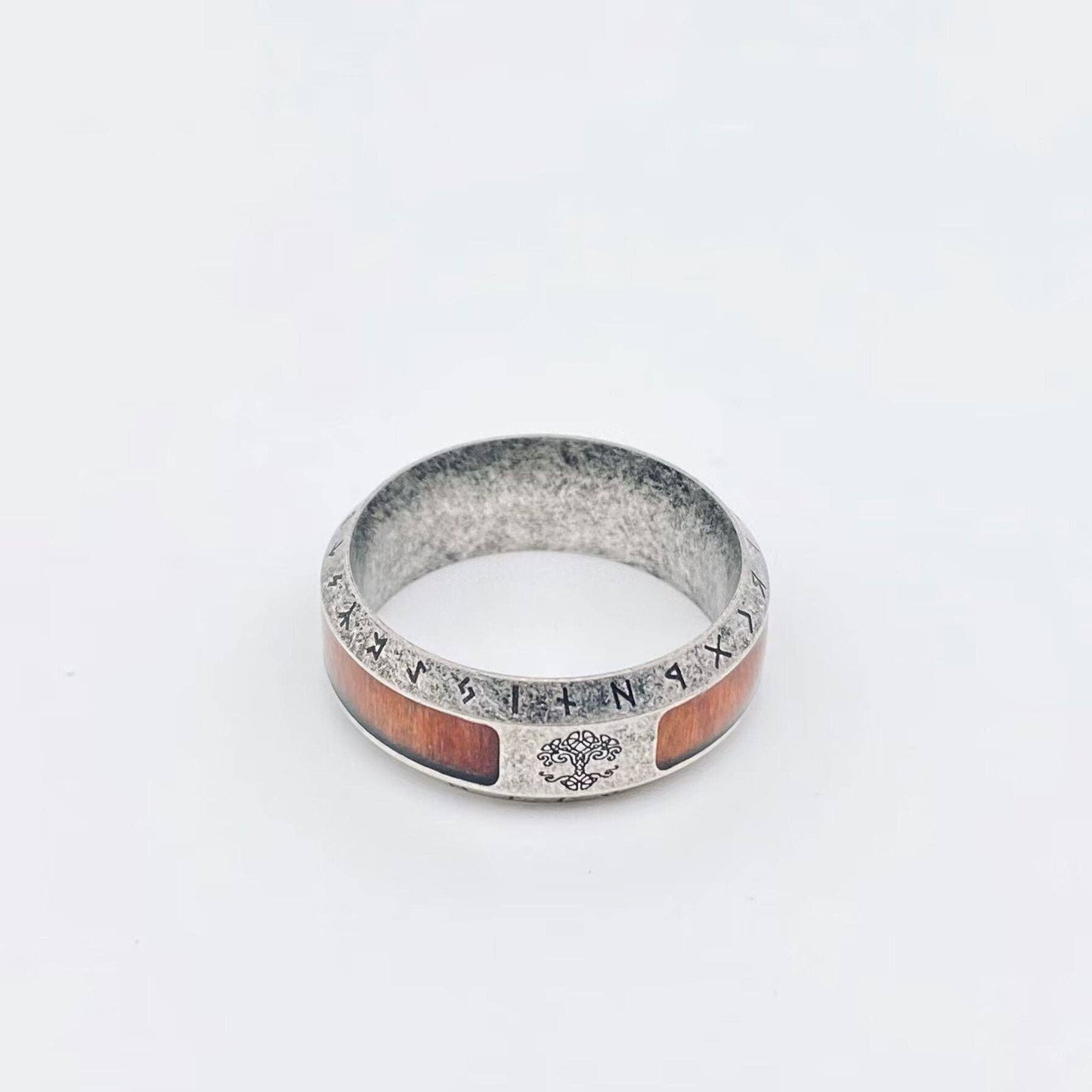 Silver ring with wooden inlay and runes, tree of life design.