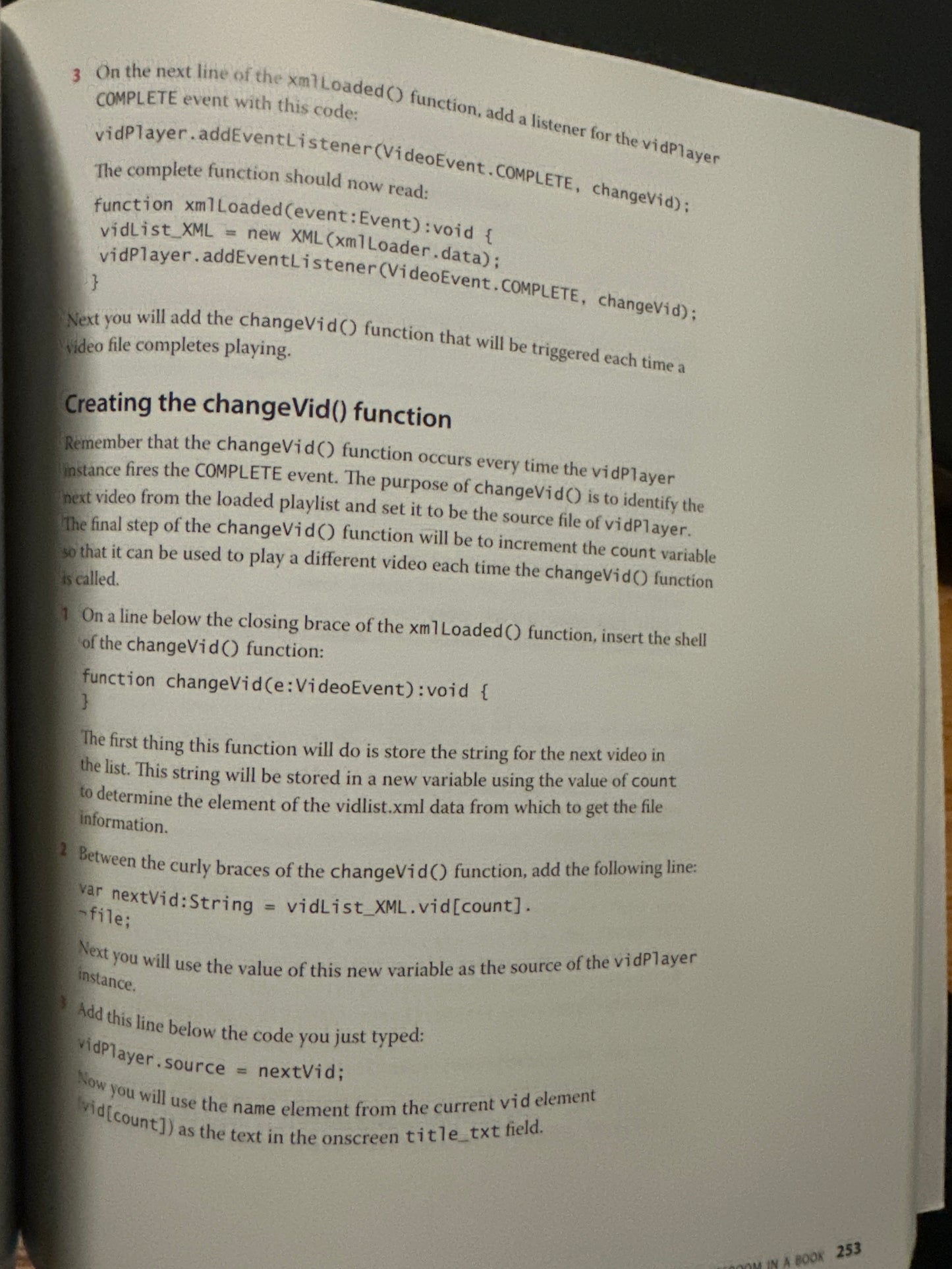 Open book page explaining video player function code.