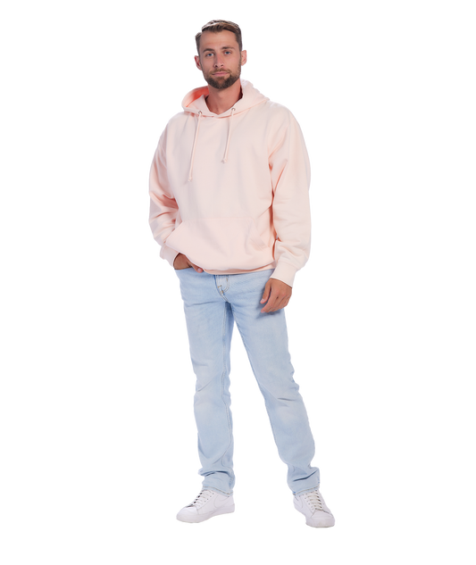 Man wearing light pink hoodie, blue jeans, and white sneakers.