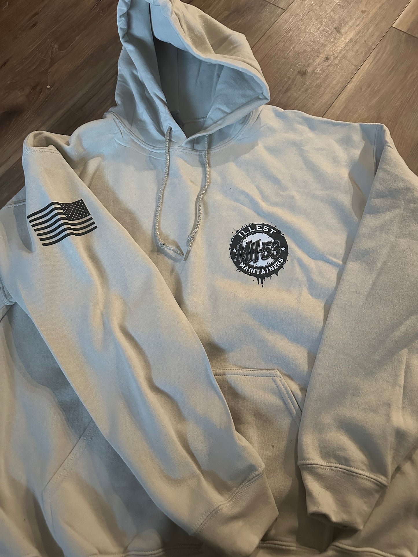 White hoodie with Illest Maintainers logo and American flag patch.