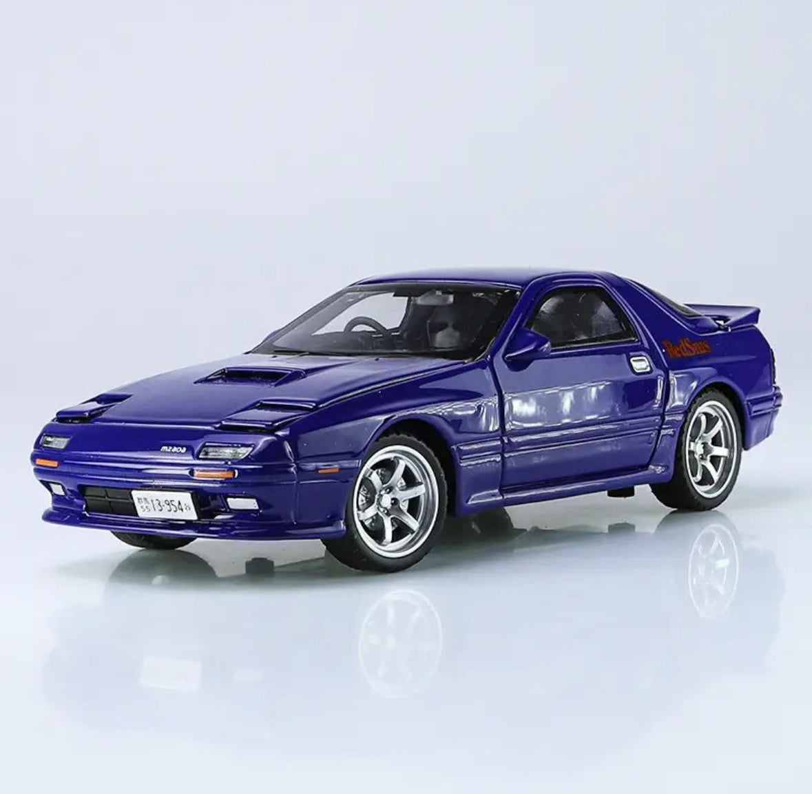 Blue Mazda RX-7 die-cast model car with Red Bull logo.
