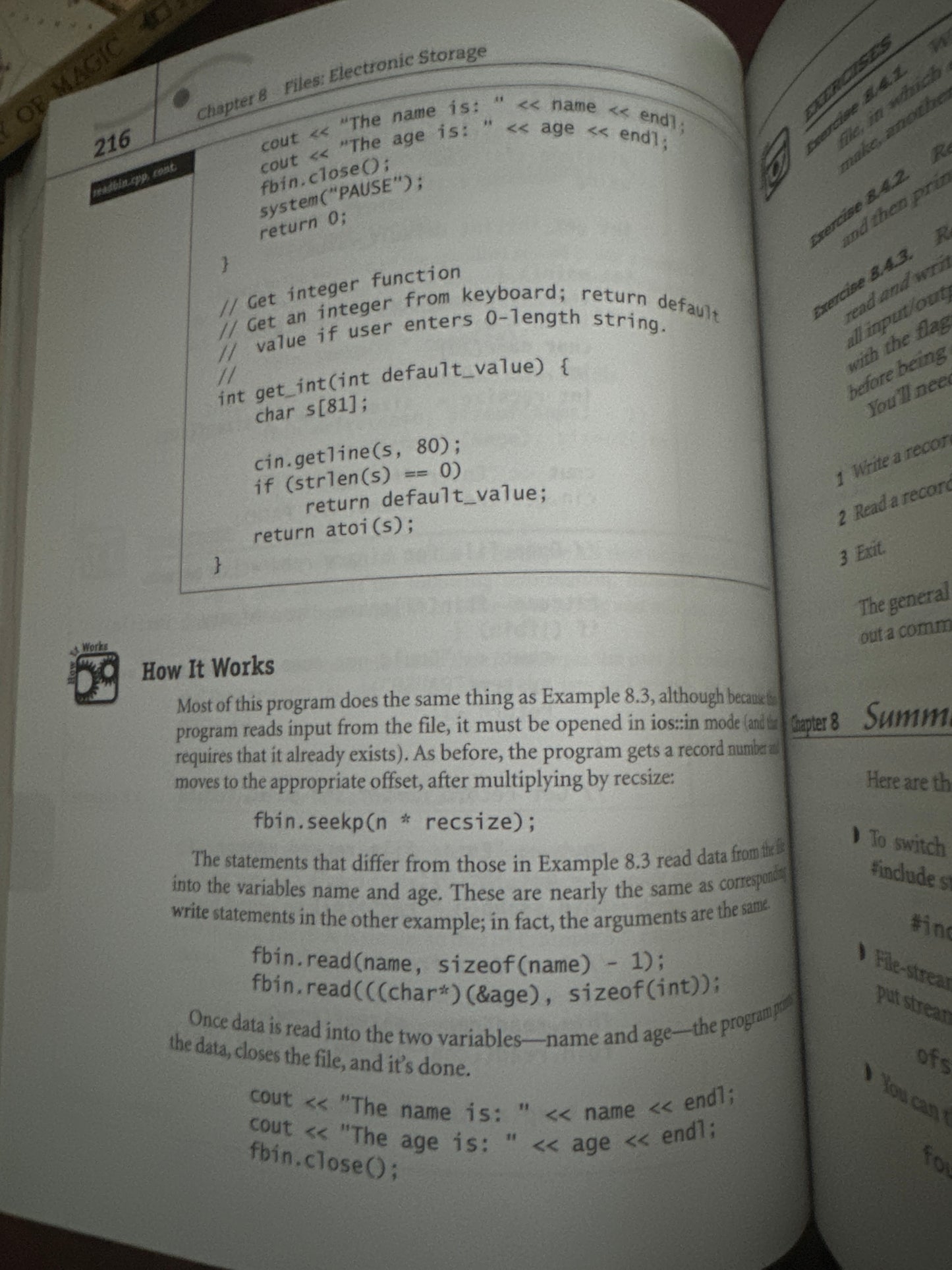 Open book page displaying C code and explanation of file operations.