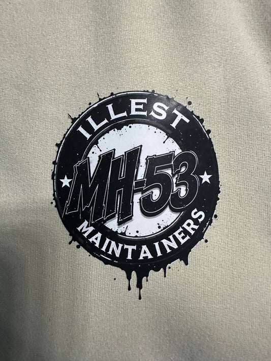 Black Illest MH-53 Maintainers logo on a light gray t-shirt.