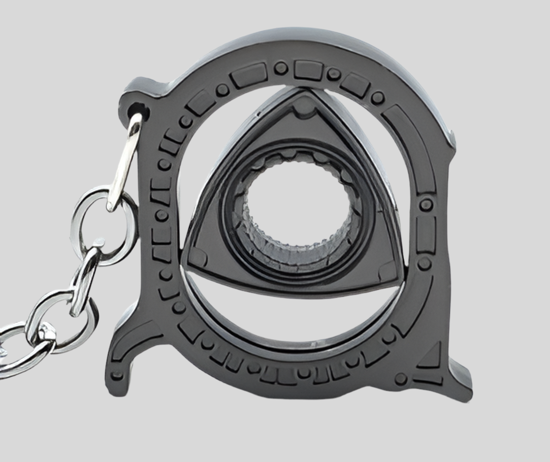 Black metal handcuff keychain with intricate design and chain.