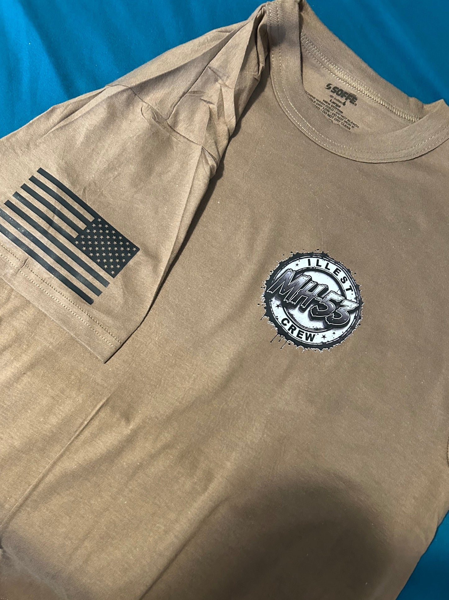 Khaki t-shirt with American flag and MH-53 Crew logo on blue background.