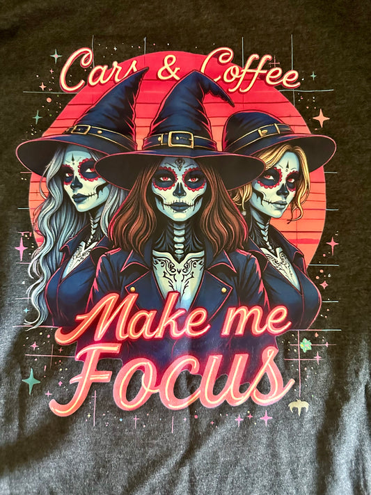 Vintage-style t-shirt featuring three witches with sugar skull makeup and Cars Coffee Make me Focus text.