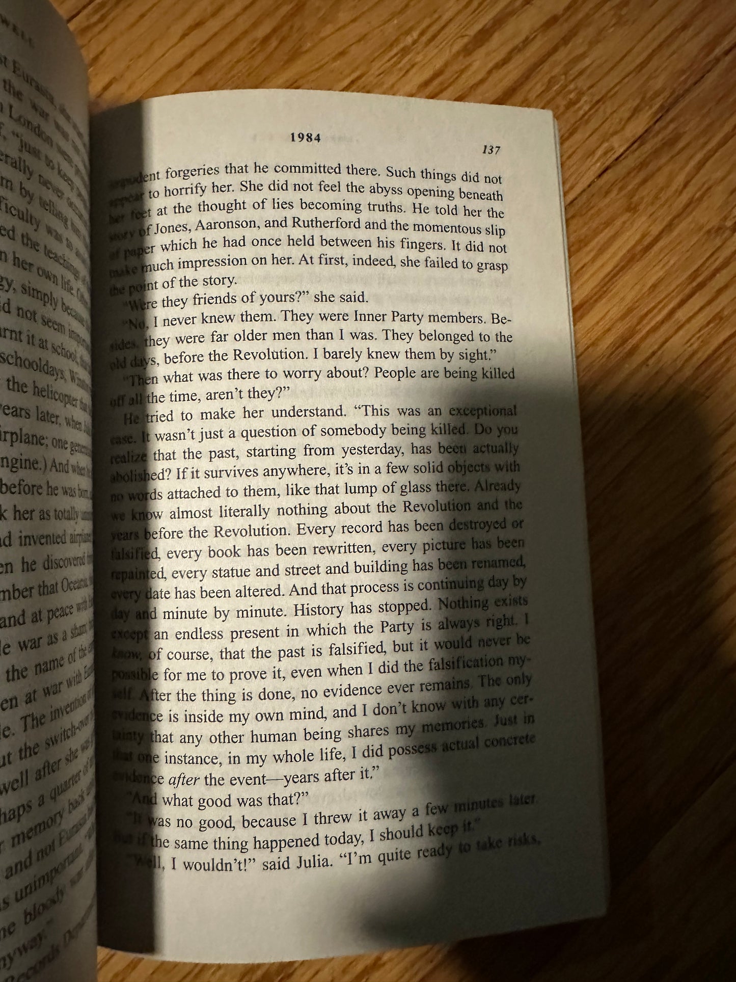 Open book page with text on a wooden surface.