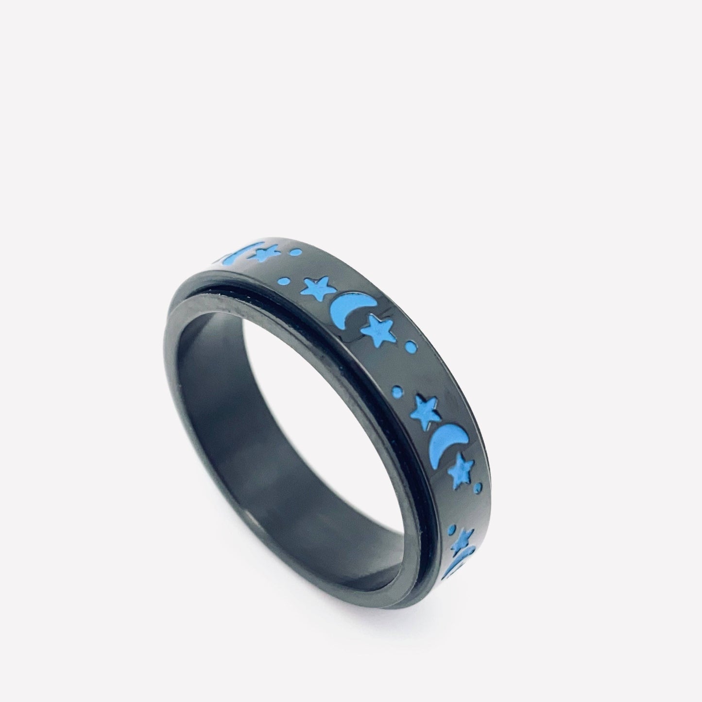 Black ring with blue moon and star designs on a white background.