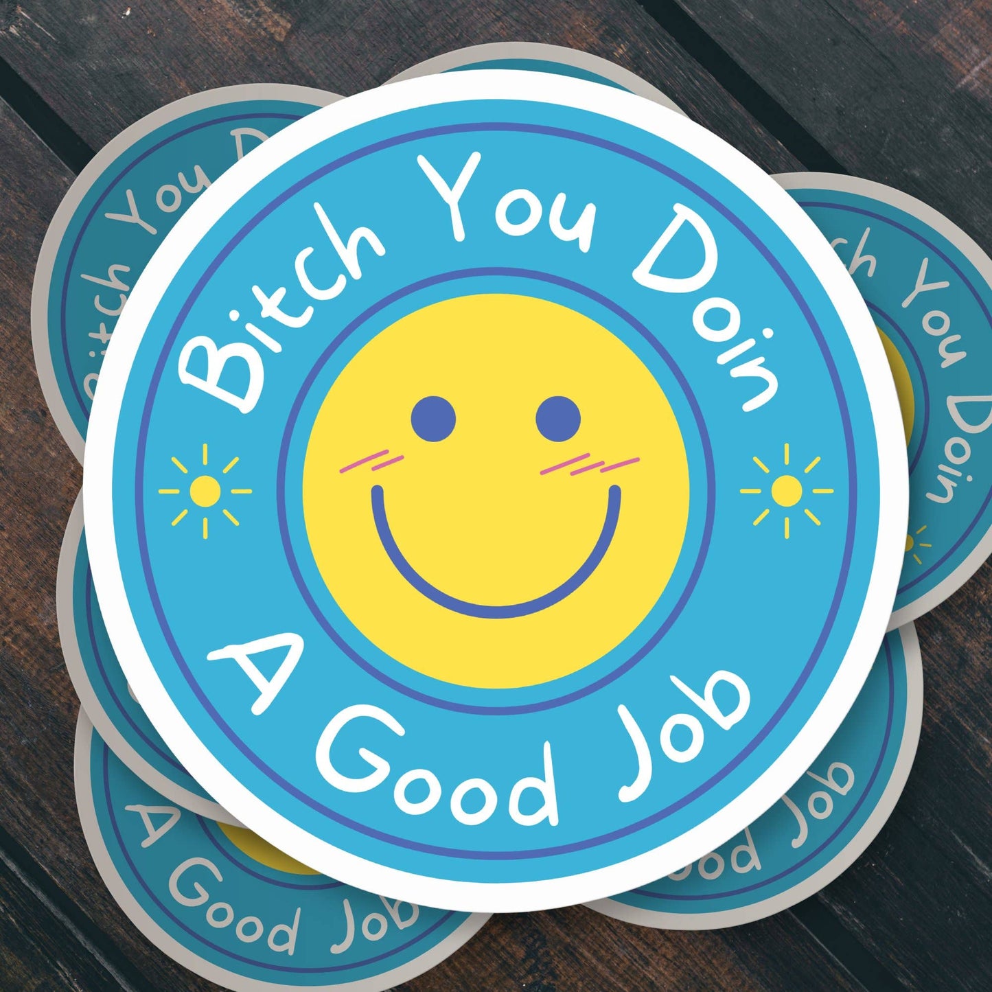 Circular sticker with Bitch You Doin A Good Job and smiley face on blue background.