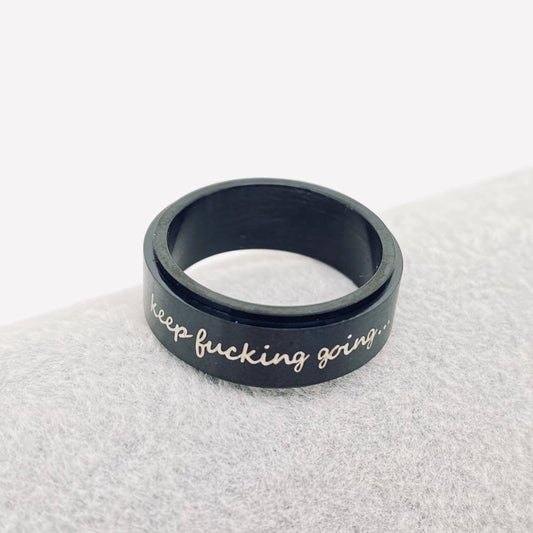 Black motivational ring with keep fucking going... engraved.