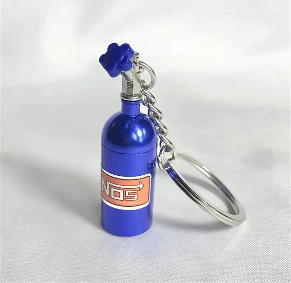 Blue NOS nitrous oxide bottle keychain with silver ring.