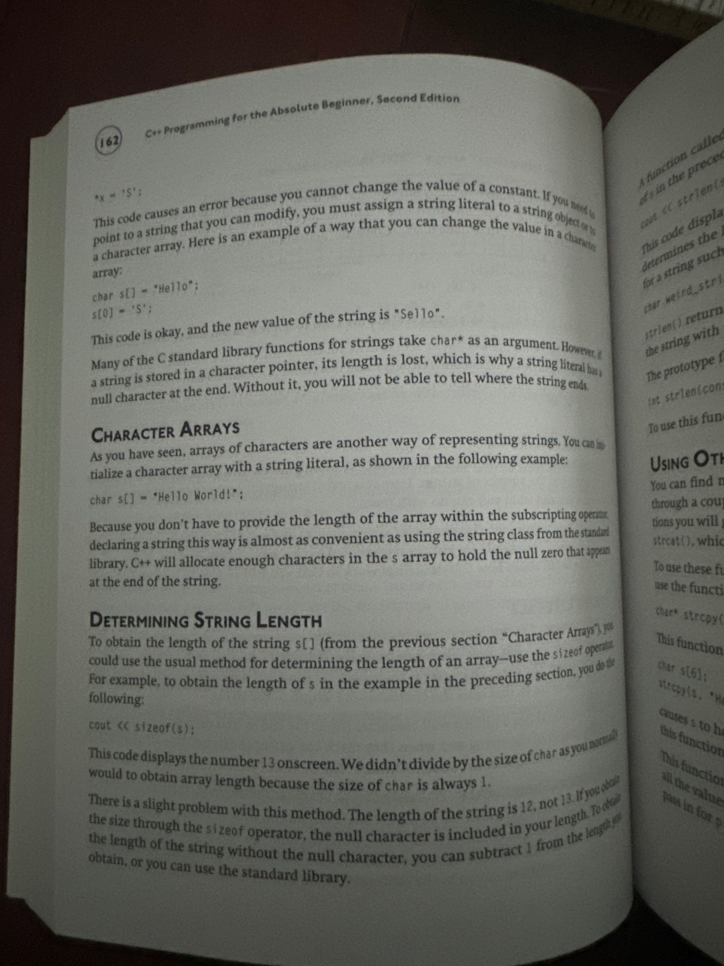 Open book page explaining C string arrays and length determination.
