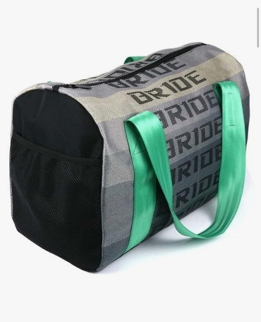 Gray duffel bag with DRIDE text, green handles, mesh pocket.