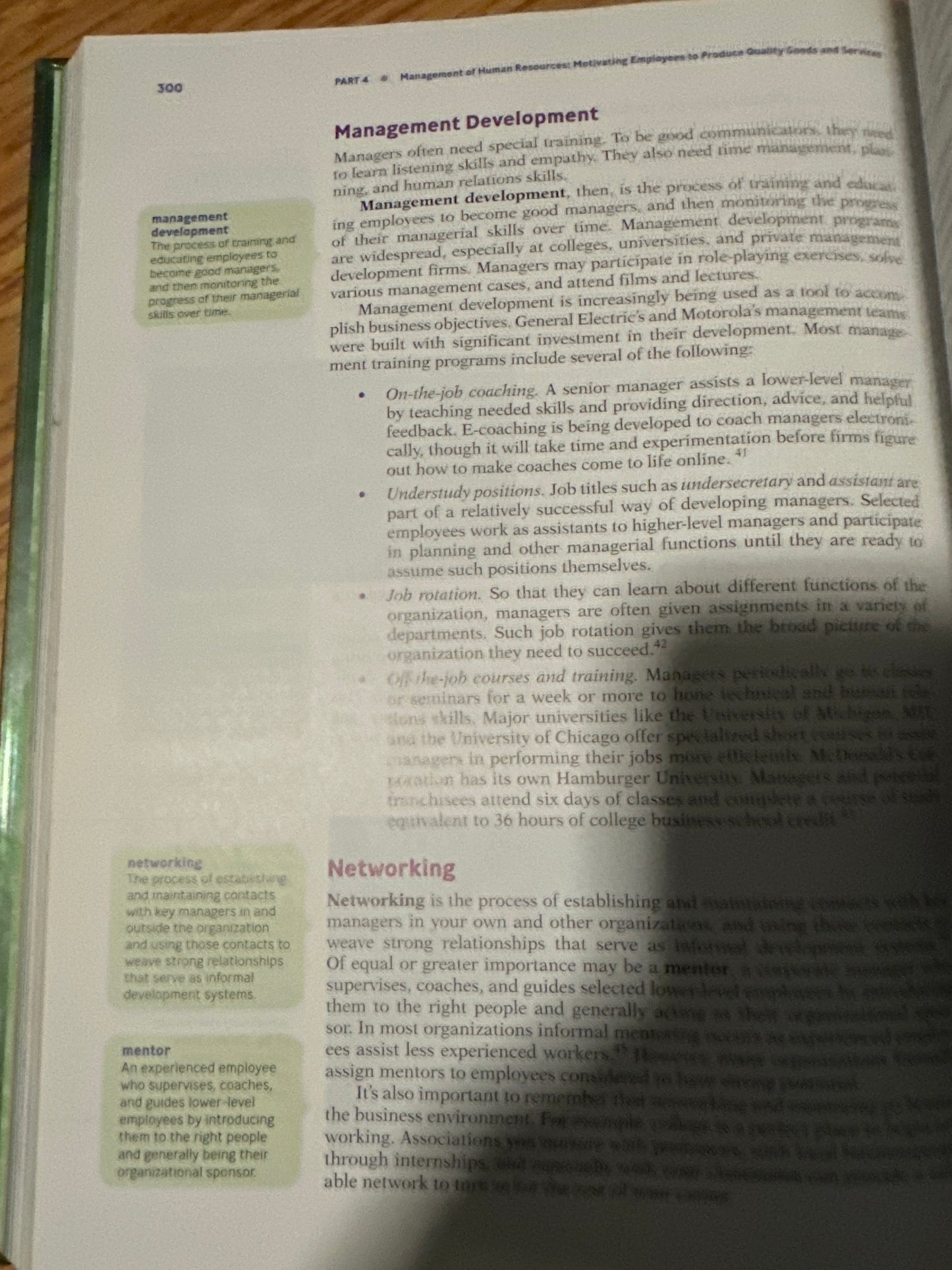 Book page open to Management Development section, discussing skills and training for managers.