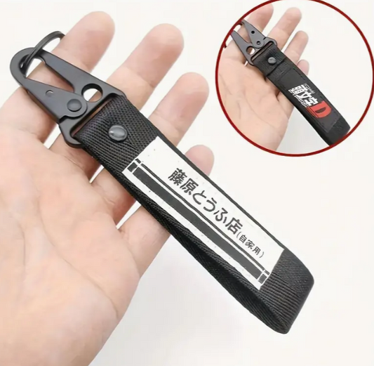 Black carabiner with text and red D logo keychain.