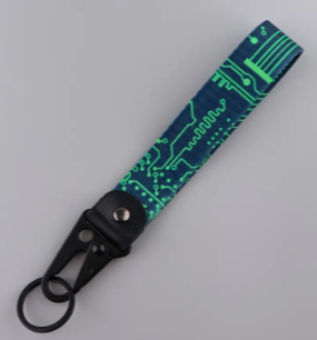 Circuit board patterned keychain with black strap and clip.