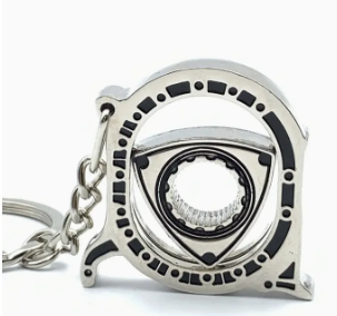 Silver gear-shaped keychain with intricate design and central circular element.