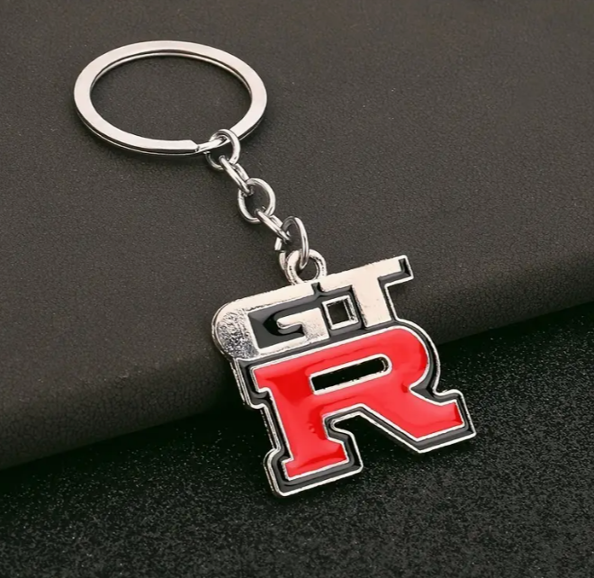 Red and black GT-R logo keychain with silver ring.