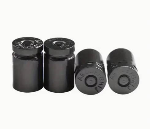 Four black vials with labeled caps on a white background.
