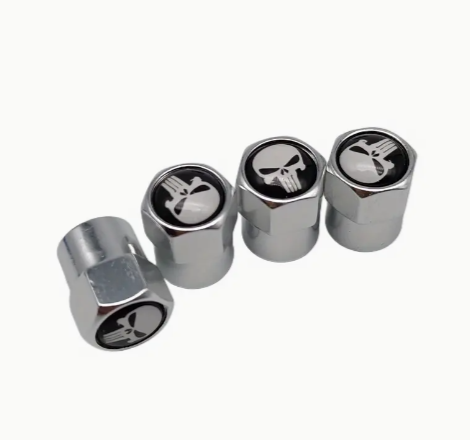 Chrome car tire valve caps with skull and crossbones design.
