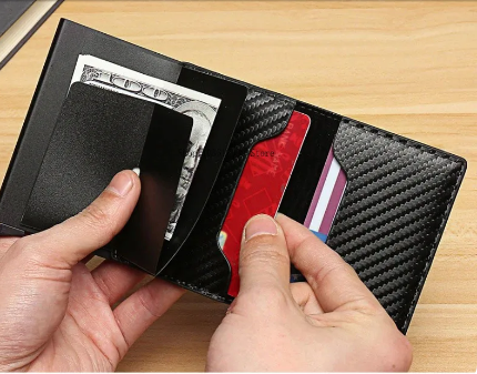 Black carbon fiber wallet with money and cards.