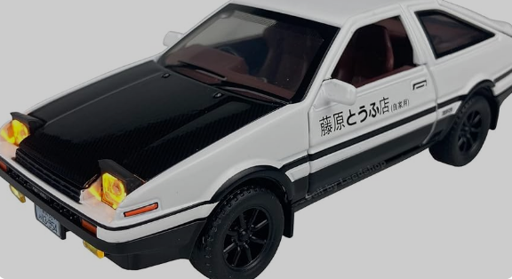 White and black toy car with Japanese text on the side.