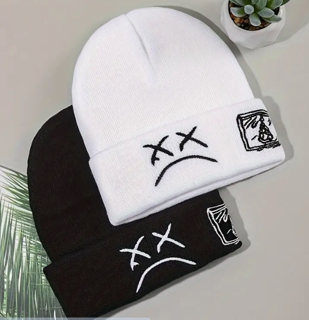 White and black beanie hats with abstract designs.