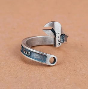 Silver adjustable wrench ring with 925 hallmark on band.