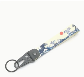 Vintage Japanese wave keychain with red sun design.