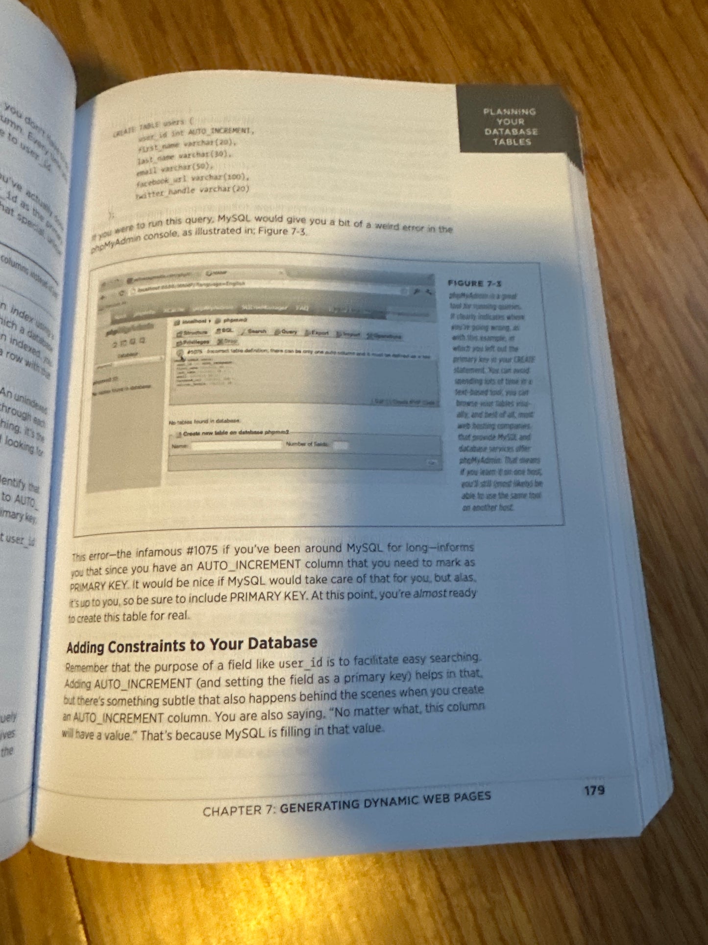 Open book page showing MySQL database table creation and constraints explanation.