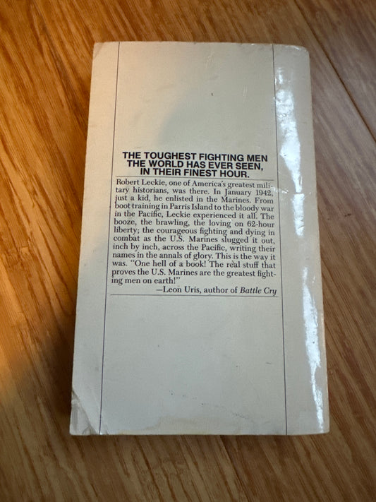 Back cover of The Toughest Fighting Men book on wooden surface.