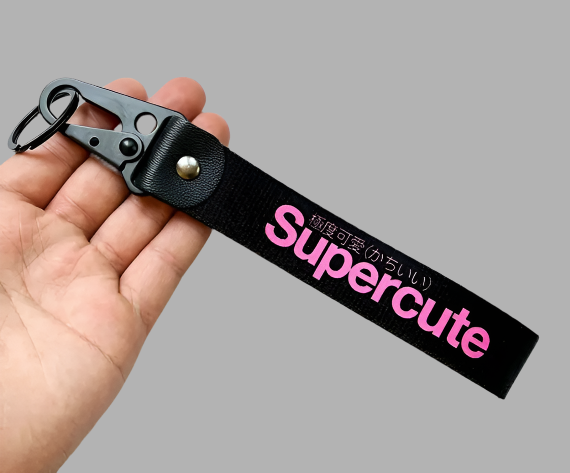 Black keychain with Supercute in pink and Japanese text.