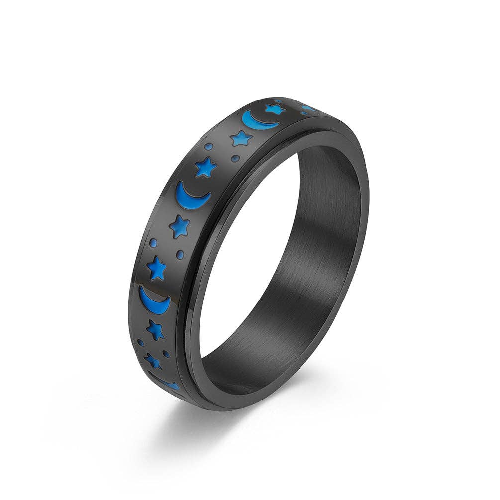 Black ring with blue moon and star designs on a white background.