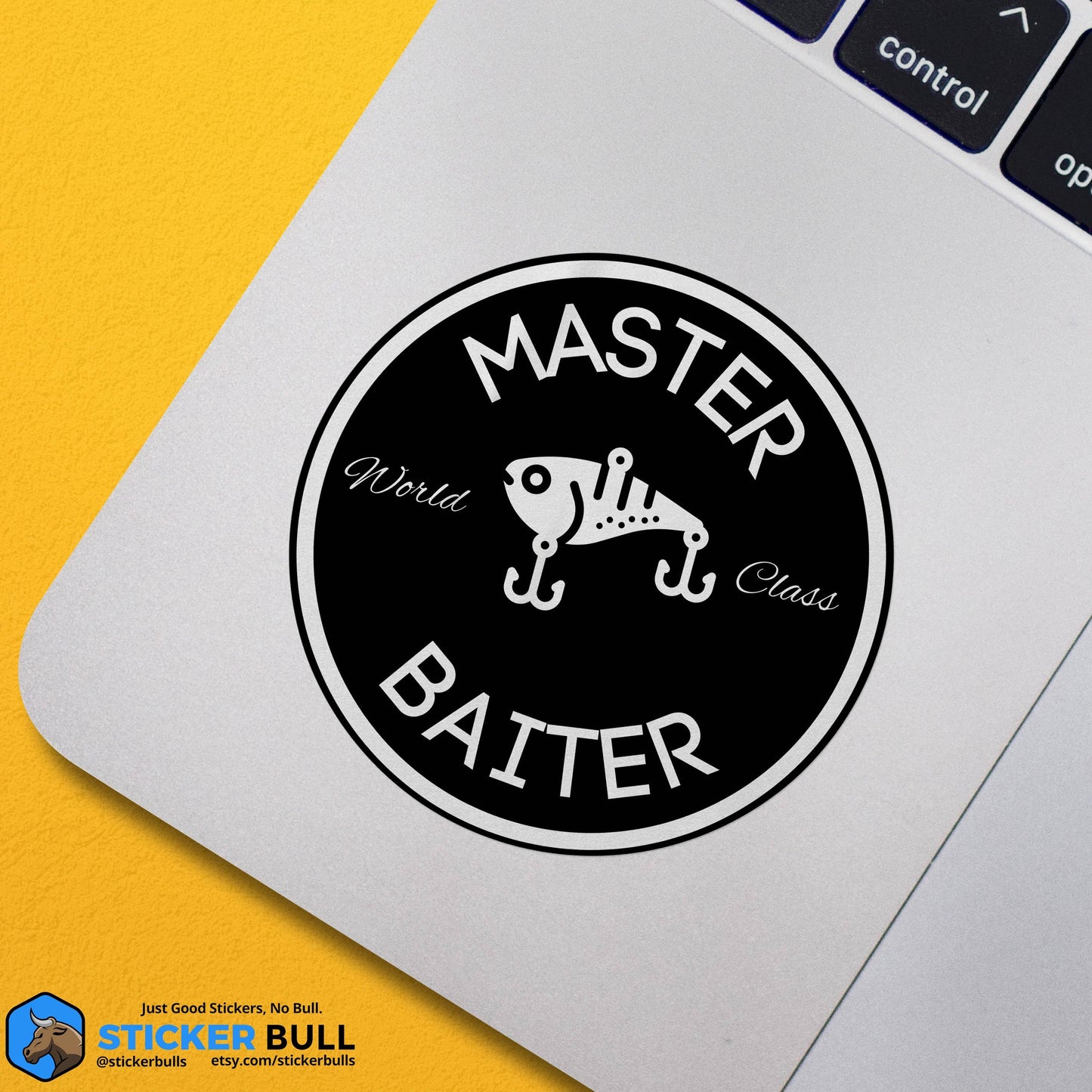 Round Master Baiter sticker with fishing lure design on laptop.
