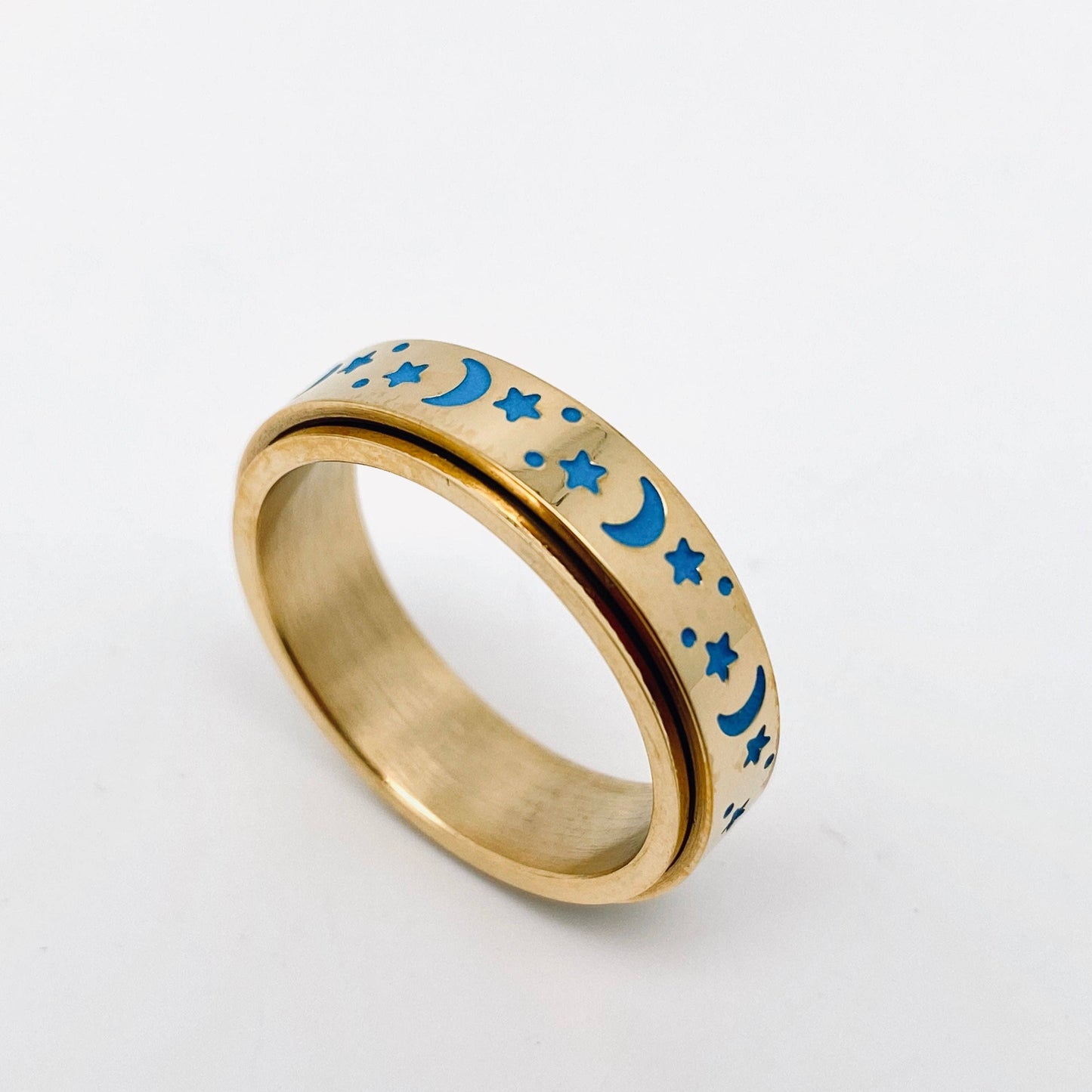 Gold spinner ring with blue moon and star designs.